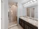 Bathroom boasts a double vanity and glass enclosed shower, providing style and functionality at 10436 Rivercrest Dr, Riverview, FL 33578