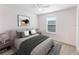 Comfortable bedroom with a ceiling fan, neutral walls, an area rug, and a large window with natural light at 10436 Rivercrest Dr, Riverview, FL 33578