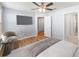 This comfortable bedroom has hardwood floors, a ceiling fan, sitting area, and an ensuite bathroom and closets at 10436 Rivercrest Dr, Riverview, FL 33578