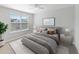Bright bedroom with a ceiling fan, neutral walls, an area rug, and a large window with natural light at 10436 Rivercrest Dr, Riverview, FL 33578
