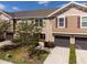Inviting townhome featuring a well-manicured lawn, attached garage, and neutral-toned siding with charming accent shutters at 10436 Rivercrest Dr, Riverview, FL 33578