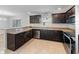 Beautiful kitchen featuring sleek countertops, dark cabinetry and stainless steel appliances for a modern touch at 10436 Rivercrest Dr, Riverview, FL 33578