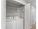 This laundry room is equipped with shelves, washer, and dryer at 10436 Rivercrest Dr, Riverview, FL 33578