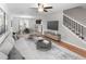 Spacious living room with an open floor plan that flows into dining area, featuring stylish decor and modern finishes at 10436 Rivercrest Dr, Riverview, FL 33578