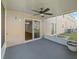 Covered outdoor patio featuring an outdoor ceiling fan and sliding glass door access to the home's interior at 10436 Rivercrest Dr, Riverview, FL 33578