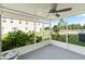 Covered outdoor patio featuring an outdoor ceiling fan and views of the backyard and neighboring property at 10436 Rivercrest Dr, Riverview, FL 33578