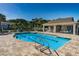 Sparkling community pool with a pool house, lounge chairs, and pristine blue water at 10436 Rivercrest Dr, Riverview, FL 33578