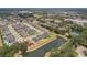 Aerial view of a residential area with a lake and houses, showcasing the neighborhood layout at 10736 Whitland Grove Dr, Riverview, FL 33578