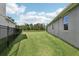 A spacious backyard featuring lush green grass and a fence enclosing the property at 10736 Whitland Grove Dr, Riverview, FL 33578