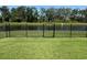 Backyard featuring a black iron fence and gate providing access to a serene waterfront view at 10736 Whitland Grove Dr, Riverview, FL 33578