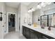 Bathroom with double vanity, modern fixtures, a walk-in closet, and a frameless glass shower at 10736 Whitland Grove Dr, Riverview, FL 33578