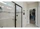 Modern bathroom featuring a large shower with a sleek black frame, mosaic tile accent, and convenient corner shelves at 10736 Whitland Grove Dr, Riverview, FL 33578