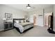 Comfortable bedroom with neutral colors, carpeted floors and ensuite bathroom at 10736 Whitland Grove Dr, Riverview, FL 33578