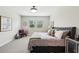Comfortable bedroom with a tufted headboard bed, bright windows, and stylish decor, creating a relaxing retreat at 10736 Whitland Grove Dr, Riverview, FL 33578