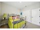 Cozy bedroom featuring a metal bed frame with bright yellow bedding, offering a comfortable and inviting atmosphere at 10736 Whitland Grove Dr, Riverview, FL 33578
