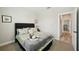 Cozy bedroom with stylish bedding, and an ensuite entrance, creating a relaxing retreat at 10736 Whitland Grove Dr, Riverview, FL 33578