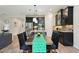 Dining area with table for six, modern light fixtures, and an open view of the kitchen at 10736 Whitland Grove Dr, Riverview, FL 33578