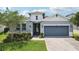 Charming home with a well-maintained front yard, a two-car garage, and stylish curb appeal at 10736 Whitland Grove Dr, Riverview, FL 33578