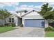 Charming single-Gathering home with a manicured lawn and a blue two-car garage at 10736 Whitland Grove Dr, Riverview, FL 33578