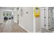 Hallway showcasing luxury vinyl floors, neutral paint and a decorative mirror at 10736 Whitland Grove Dr, Riverview, FL 33578