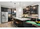 Beautiful kitchen with stainless steel appliances, dark cabinets, a large island, and breakfast bar seating at 10736 Whitland Grove Dr, Riverview, FL 33578