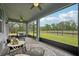 Inviting screened lanai with comfortable seating and ceiling fans, perfect for outdoor relaxation and entertaining at 10736 Whitland Grove Dr, Riverview, FL 33578