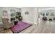 Bright living room features a purple paisley rug, a work area, and an open floor plan at 10736 Whitland Grove Dr, Riverview, FL 33578