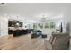 Open concept living space with wood floors, dark cabinets and view of the kitchen island at 10736 Whitland Grove Dr, Riverview, FL 33578