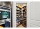 Walk-in pantry with custom shelving, providing ample storage for food and kitchen essentials at 10736 Whitland Grove Dr, Riverview, FL 33578