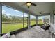Enjoy the view of the water from this screened porch, complete with ceiling fans and outdoor furniture at 10736 Whitland Grove Dr, Riverview, FL 33578