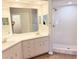 Bright bathroom with a double sink vanity and a walk-in shower featuring white tile at 11351 Shipwatch Ln # 1844, Largo, FL 33774
