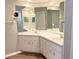 Bathroom vanity with double sinks, white cabinets, and neutral countertop at 11351 Shipwatch Ln # 1844, Largo, FL 33774
