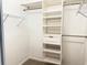 Walk-in closet with neutral carpet and built-in shelving units at 11351 Shipwatch Ln # 1844, Largo, FL 33774