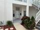 Inviting front entrance with white door, landscaping and staircase to upper level at 11351 Shipwatch Ln # 1844, Largo, FL 33774