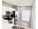 Modern kitchen with stainless steel appliances, white cabinetry, and hardwood flooring at 11351 Shipwatch Ln # 1844, Largo, FL 33774