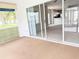 Enclosed lanai with carpet; sliding glass doors let in plenty of natural light at 11351 Shipwatch Ln # 1844, Largo, FL 33774