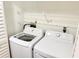 Bright laundry room with LG washer and dryer and white wire shelving for organizing laundry essentials at 11351 Shipwatch Ln # 1844, Largo, FL 33774