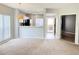 Open-concept living room featuring a kitchen view and carpet flooring at 11351 Shipwatch Ln # 1844, Largo, FL 33774