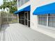 Covered patio with weathered wood, screened enclosure, and blue awnings at 11351 Shipwatch Ln # 1844, Largo, FL 33774