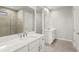 Modern bathroom features a double vanity, stone tile and glass enclosed shower at 11470 Myakka Blue Dr, Venice, FL 34293