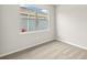 Small bedroom has neutral paint and carpet with single window overlooking yard at 11470 Myakka Blue Dr, Venice, FL 34293