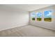 Bedroom with neutral paint and three windows providing natural light at 11470 Myakka Blue Dr, Venice, FL 34293