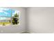 Bedroom has neutral paint and carpet with single window overlooking yard at 11470 Myakka Blue Dr, Venice, FL 34293