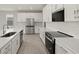 Bright kitchen with white cabinets, stainless steel appliances, and a stylish backsplash at 11470 Myakka Blue Dr, Venice, FL 34293