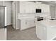 Well-equipped kitchen featuring stainless steel appliances, a center island, and ample cabinet space at 11470 Myakka Blue Dr, Venice, FL 34293
