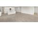 Open-concept living area with gray tile flooring and a modern kitchen featuring a center island at 11470 Myakka Blue Dr, Venice, FL 34293