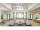 A spacious and inviting lounge area with high ceilings, modern furniture, and stylish decor at 11470 Myakka Blue Dr, Venice, FL 34293