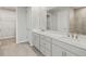 Bathroom featuring a double sink vanity with gray cabinets and tile flooring at 11520 Myakka Blue Dr, Venice, FL 34293