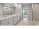 Elegant bathroom with double vanity, tiled shower, and tile flooring at 11520 Myakka Blue Dr, Venice, FL 34293
