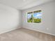 Cozy carpeted bedroom with large window letting in natural light and views at 11520 Myakka Blue Dr, Venice, FL 34293